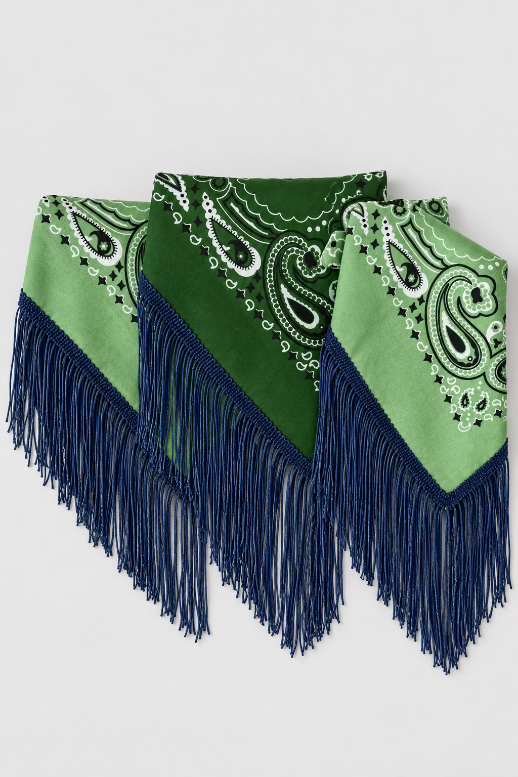 A green fringed bandana with paisley patterns, featuring dark green fringe and navy blue fringe, displayed against a plain white background.